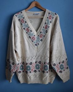 Vintage oversized floral pattern sweater, from the 1990s era Hipster slouchy sweater with a deep V neck and floral pattern in soft colors - creamy white, mint green, pastel pink Material - 40% cotton, 40% acrylic, 20% linen Size - marked M, Model in the photos wears M, will fit as L as well To be sure this item will fit you please look at measurements below: Measurements (taken while sweater is lying flat, double armpit to armpit and bottom): Shoulders (from seam to seam) - 26.5 inches / 67.3 cm Vintage Relaxed Fit Sweater For Spring, Oversized Cotton V-neck Sweater For Spring, Bohemian Fair Isle Sweater For Spring, Vintage Floral Print Winter Tops, Vintage Long Sleeve Sweater With Letter Print, V-neck Sweater With Floral Print For Fall, Vintage Winter Floral Print Tops, Vintage Patterned Crew Neck Sweater, Cream Knit Sweater With Floral Embroidery