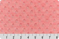 a ruler is shown with an image of pink polka dots on the side of it