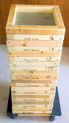 a stack of wooden crates sitting on top of a carpeted floor