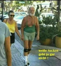 an old man walking down the street with his leg in cast and knee braces