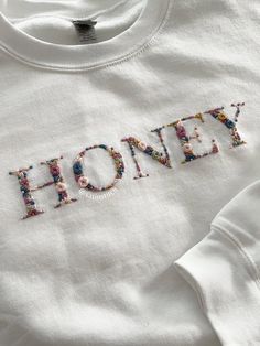 a white shirt with the word honey printed on it