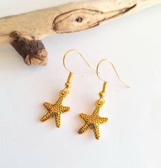 These pretty Starfish drop earrings are gold plated alloy The ear wires are gold plated stainless steel. They are hypoallergenic, lead and nickel free. Total length of earring is 20mm and width is 12mm. Maintenance To keep your jewellery in tip top condition wipe over with a damp cloth. Avoid contact with chemicals. Store away in your jewellery box. Thank you for looking! Gold Starfish Earrings Nickel Free, Gold Nickel-free Starfish Earrings, Nickel-free Gold Starfish Earrings, Gold Star Earrings With Ear Wire, Gold Star-shaped Earrings With Ear Wire, Gold Starfish Charm Drop Earrings, Handmade Gold Star Earrings, Gold Star-shaped Earrings For Beach, Gold Dangle Earrings With Starfish Charm