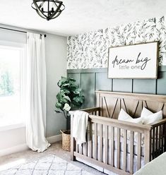 a baby's room with a crib in the corner and a large window