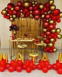 red and gold balloons are on display at a party