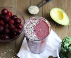 the smoothie is ready to be eaten on the table with cherries and avocado