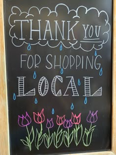 a chalkboard sign that says thank you for shopping local