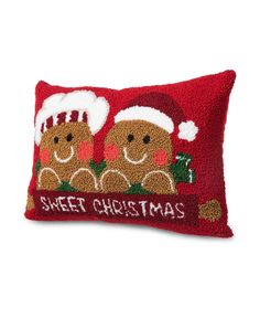 a red pillow with two gingerbreads on it and the words sweet christmas written in white