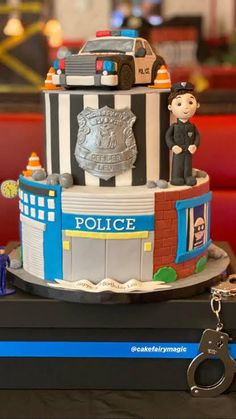 a police cake is sitting on a table with a keychain hanging from it