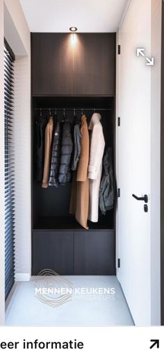 an open closet with coats and jackets hanging on the wall, next to a door