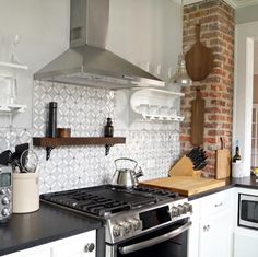 a stove top oven sitting inside of a kitchen next to a microwave and toaster oven