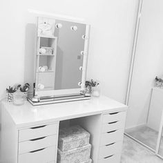 there is a vanity with drawers and a mirror on the wall in this room,