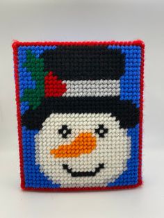 a close up of a beaded snowman on a white background