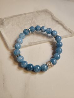 "Handmade (pre-made or made to order) beautiful crystal jewelry.  Let me know what size you want (by measuring your wrist and keeping in mind if you want it snug or a little loose) or it will be a standard 7\".  All genuine stones and are 8 MM with a 1 MM stretch cord that I also glue so they hold up well with everyday gentle care and use, but remember... ROLLING them off/on your wrist will help them hold up longer.  I can also add additional lava stones for essential oil diffusing!  Tell me you Beaded Aquamarine Bracelet For Gift, Aquamarine Beaded Bracelets As Gift, Aquamarine Beaded Bracelet As Gift, Adjustable Aquamarine Beaded Bracelets, Beaded Aquamarine Bracelets, Aquamarine Gemstone Beaded Bracelets, Adjustable Aquamarine Beaded Bracelets As Gifts, Adjustable Aquamarine Beaded Bracelet As Gift, Crystal Bracelet With 8mm Beads As Gift