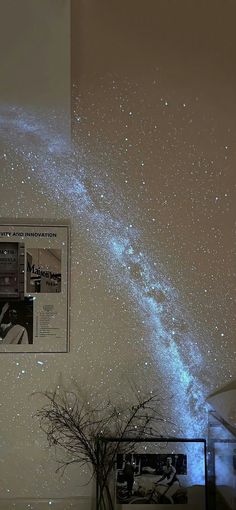 the stars are shining in the night sky above a table with a potted plant