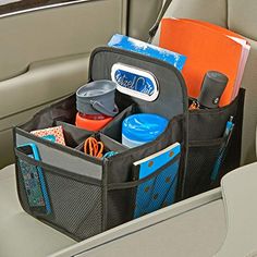 an organized car seat pocket in the back of a car, filled with personal items