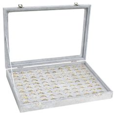 an open white box with gold flakes on the inside and bottom, sitting in front of a white background