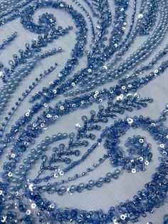 blue sequins and beads on white fabric