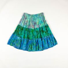 -SO SO GOOD!  -y2k rayon ruffle hem skirt  -elastic waist with drawstring  -marked one size but would best fit a small / medium  -super cool wax resist dyed fabric / multicolor madness  -no flaws to note  MEASUREMENTS waist: 12.5-16 inches flat  hips: 21 inches flat length: 21.5 inches Blue Tiered Bottoms For Vacation, Casual Green Tiered Bottoms, Casual Green Tiered Skirt, Green Bohemian Tiered Skirt, Tiered Green Beach Skirt, Bohemian Tiered Green Skirt, Bohemian Green Tiered Skirt, Green Tiered Beach Skirt, Multicolor Ruffled Mini Skirt