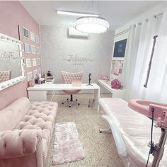 a room with pink furniture and pictures on the wall, including a couch, chair, desk, and mirror