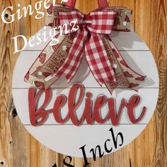 a sign that says, ginger design believe as such on the side of a wooden wall