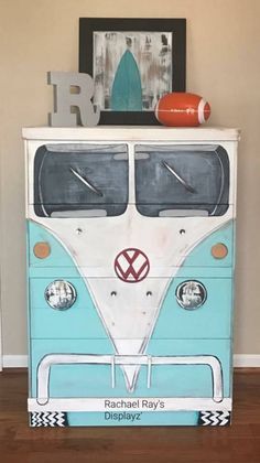 a blue and white bus painted on top of a dresser