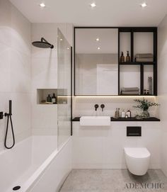 a bathroom with a toilet, sink and bathtub next to a shower head mounted on the wall