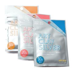 three bags of art clay sit next to each other on a white background with the words art clay silver written in japanese