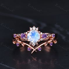 a ring with an opal and amethorate surrounded by purple sapphires