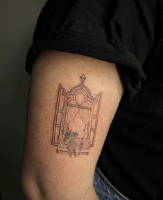 a woman's arm with a tattoo on it that has an image of a window