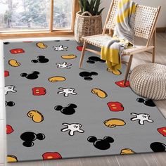 a mickey mouse rug in a room with a chair and potted plant on the floor