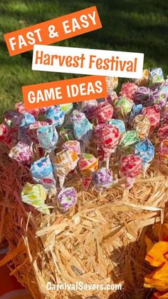 a basket filled with lollipops sitting on top of hay next to flowers