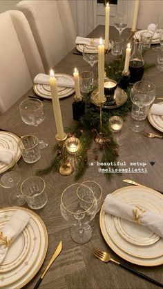 the table is set with white and gold plates