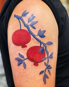 a tattoo with two pomegranates on it