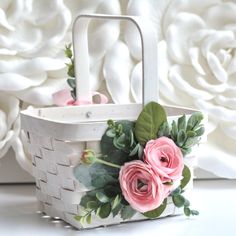 a white basket with pink flowers on it