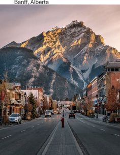 an empty street with mountains in the background