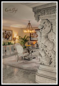 an ornately decorated living room with white chairs