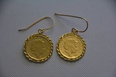 Gold coin earrings, delicate and beautiful made of an old British coin attached to a 14k gold filled hook, making them a great pair of gold dangle earrings for everyday wear. The coin earrings is made of an original coin which I decorated with twisted wires and plated with 14k gold. Dimensions: The earrings diameter is about 0.7 inch (1.8 cm). The drop length, including hook is 1 inches. The earrings are also available in sterling silver. See last 3 photos. The gold coin pendant earrings are a g Gold Coin Pendant Earrings, Coin Earrings Gold, Old British Coins, Gold Coin Earrings, Gold Coin Pendant, Antique Coins, Gold Dangle Earrings, Earrings Antique, Coin Earrings