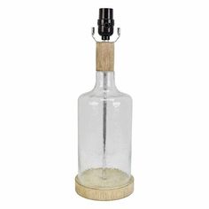 an empty glass bottle with a wooden stopper on the bottom and a black top