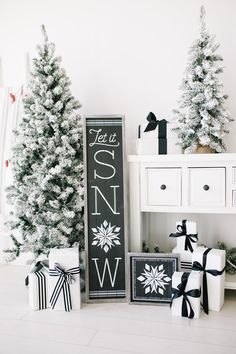 christmas trees and presents in front of a chalkboard sign