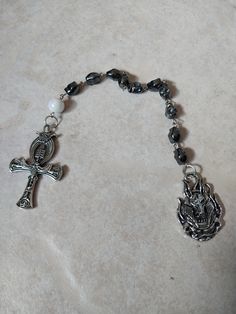 This is a deluxe version of my beautiful handmade single decade Ankh rosary. It is a stunning example of faith-inspired craftsmanship. The rosary is made with high-quality materials, including hematite beads and a scrub beetle coin pendant and finally a large white bead. ⚬ Free shipping on all orders $35 or above ⚬ If you want to buy more than one of the same rosary, message the store for special rates if supply allows.  ⚬ Each piece is handmade ⚬ Made in the USA. ⚬ More in our shop: https://www Ankh Rosary, Metal Storage Box, Storage Box With Lid, Clear Window, The Rosary, Storage Boxes With Lids, Metal Storage, Hematite Beads, Metal Box