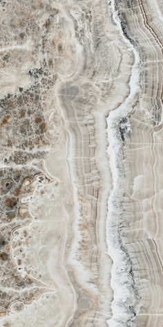 an aerial view of marble like material with brown and white streaks on the top right side