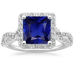 a blue sapphire and diamond ring with white diamonds on the band, set in 18k white gold