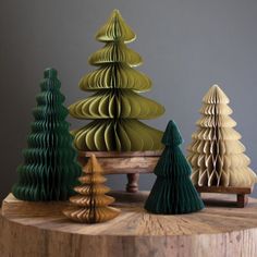 three wooden christmas trees sitting on top of a table