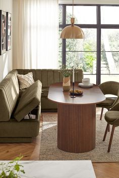 a living room filled with furniture and a large window