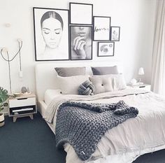 a bedroom with pictures on the wall above the bed