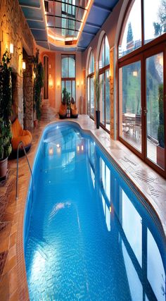 a large indoor swimming pool surrounded by windows