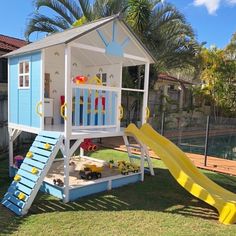 a child's play house with a slide in the yard