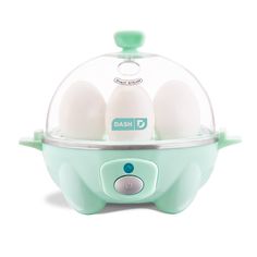 an egg cooker with three eggs in it's glass dome on the top