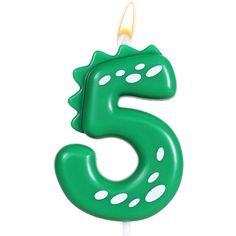 a green birthday candle with the number five on it