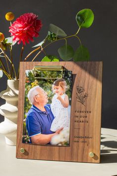 "In times of loss, small gestures of love and caring can feel like a lifeline. Give a customized gift that expresses your condolences and will last well beyond the memorial service. Engraved with details of your choosing, this picture frame is a thoughtful way to share that they will be forever in your hearts. Take your favorite photos out of the cloud and bring them into your home with our twist on the tabletop picture frame. The sleek new design holds photos with a clip so you can easily displ Gestures Of Love, Small Gestures, Name Plate Design, Forever In Our Hearts, Tabletop Picture Frames, Clip Frame, Personalised Frames, Photo Clips, Wedding Picture Frames